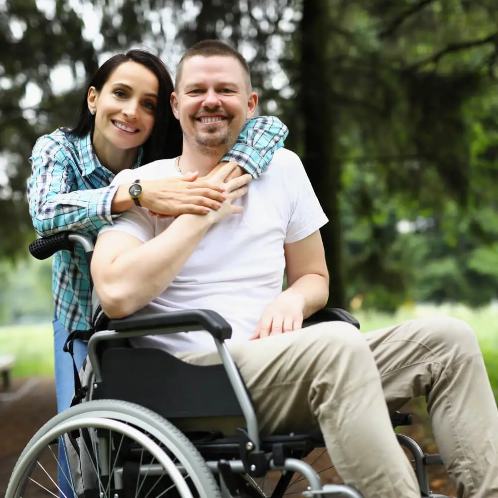 patient in wheelchair with hugging lady qualifying conditions medical marijuana texas